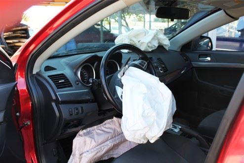 car with deployed airbags after crash
